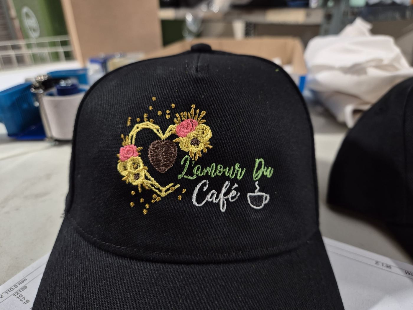 Embroidered cafe logo on a black cap