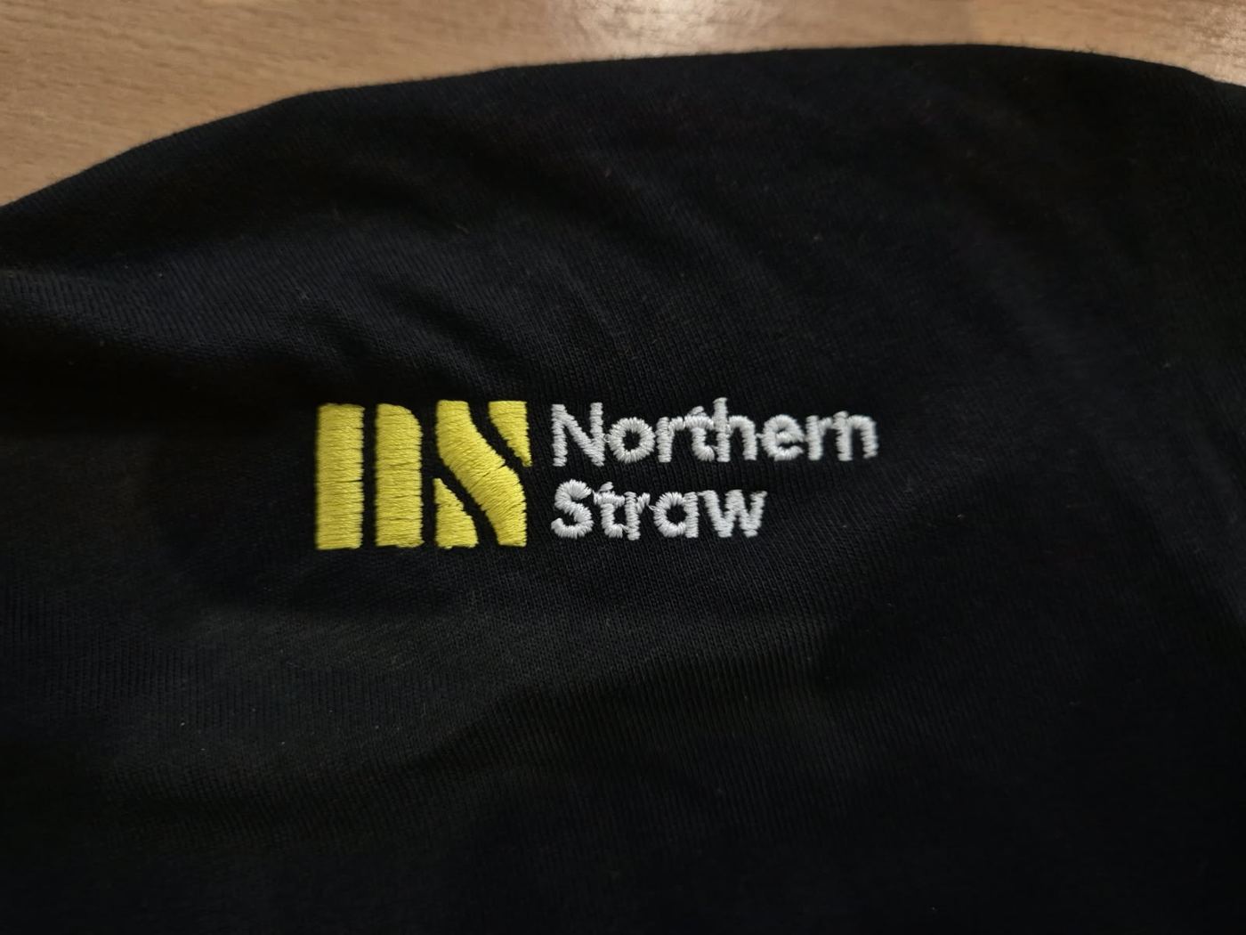 Northern Straw logo embroidered in yellow and white