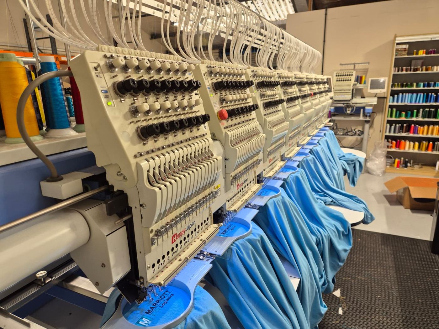 Blue shirts being embroidered on multi head machines