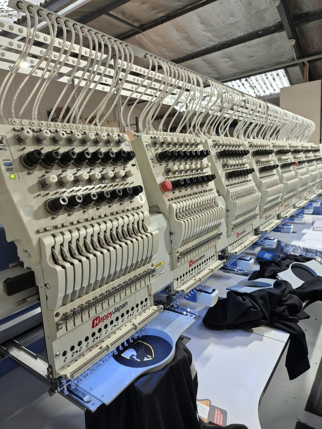 Close up of embroidery machine heads and hoops
