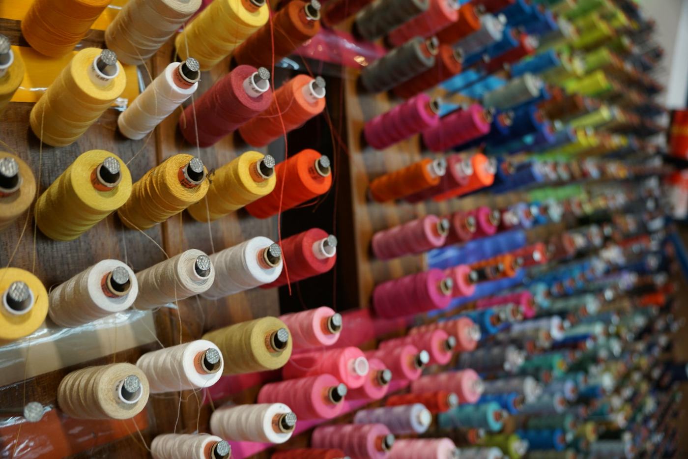 Wall of colourful embroidery thread spools